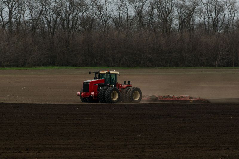 Tractor tilling soil in a field for a wildlife food plot